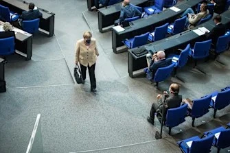 Angela Merkel leaves the Bundestag in Berlin.