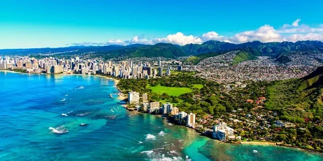 The coastline of Honolulu, Hawaii, including the base of Diamond Head Crater.