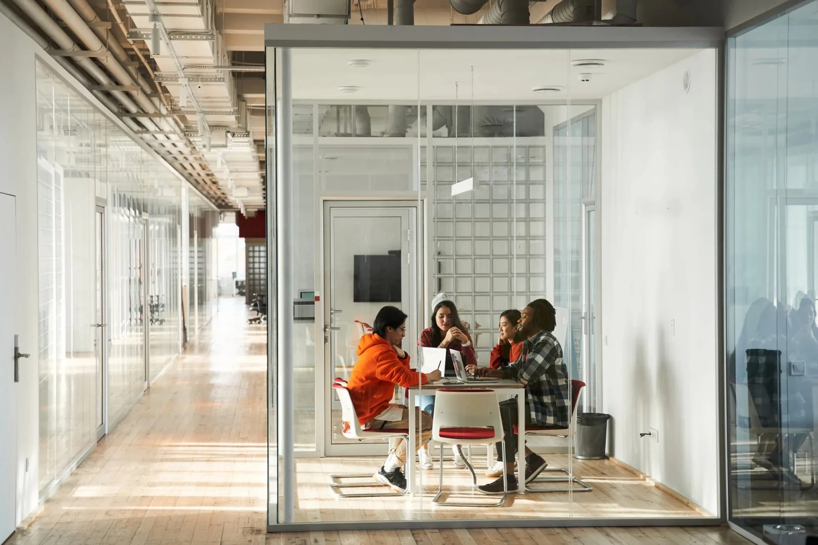 A group of people sitting at a table in a room