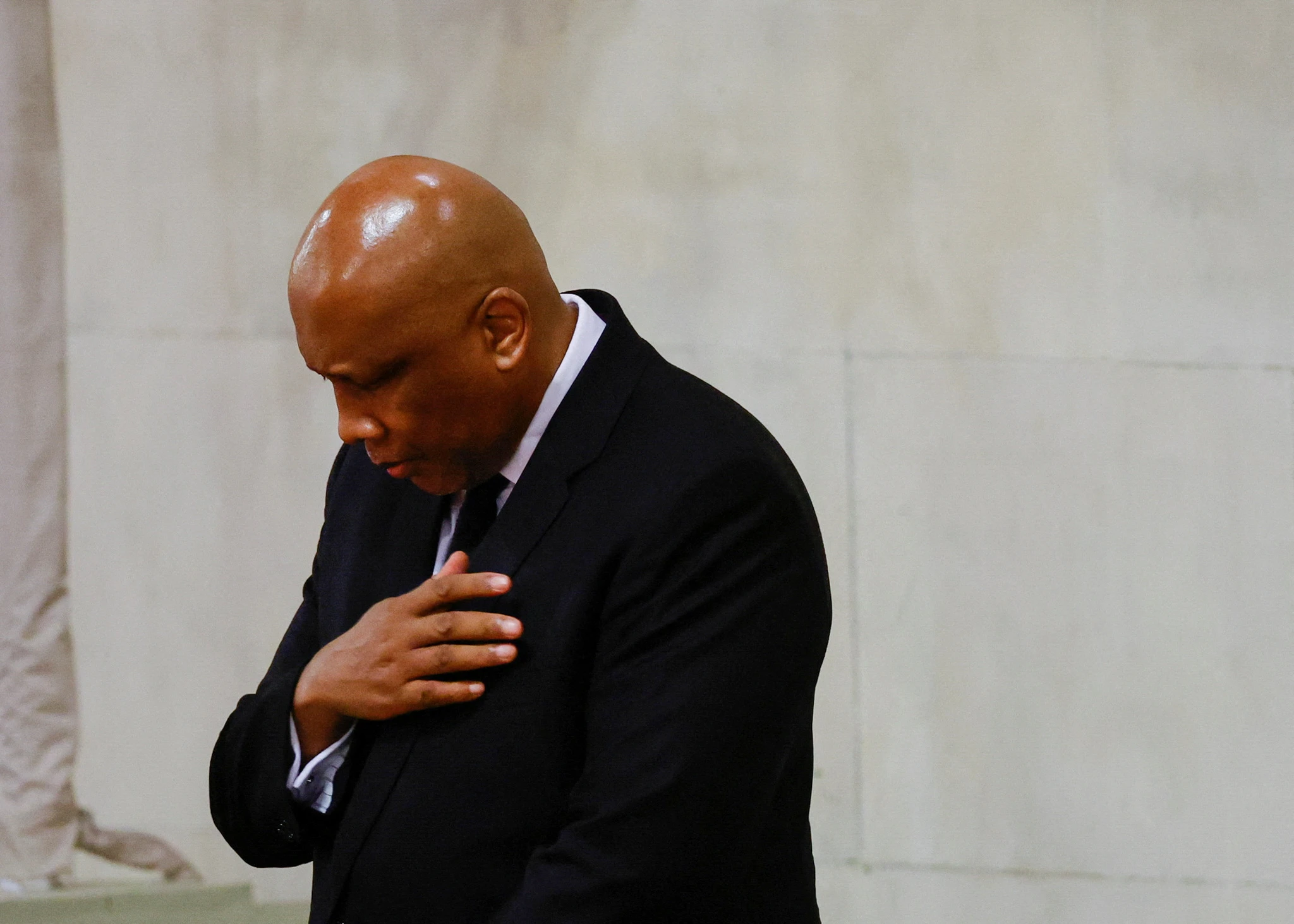 King Letsie III of Lesotho places his right hand on his heart and bows his head while paying homage to Queen Elizabeth